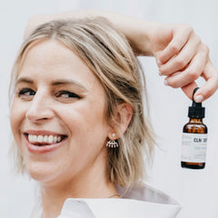 Woman holding a CLN & DRTY R&A Oil - Combo/Oily  against a white background