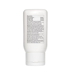 White sunscreen bottle with text on a white background