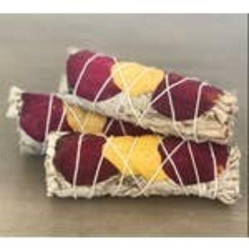 Two wrapped candies in purple and yellow with a clear wrapper on a light brown surface.