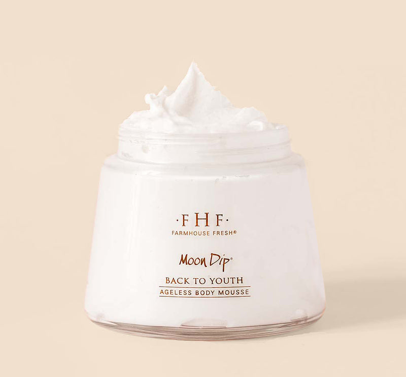 Jar of Farmhouse Fresh Moon Dip Back to Youth Ageless Body Mousse on a beige background