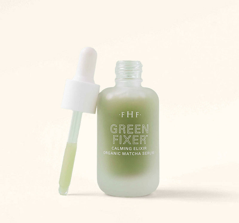 Green Fixer bottle with dropper on a light beige background
