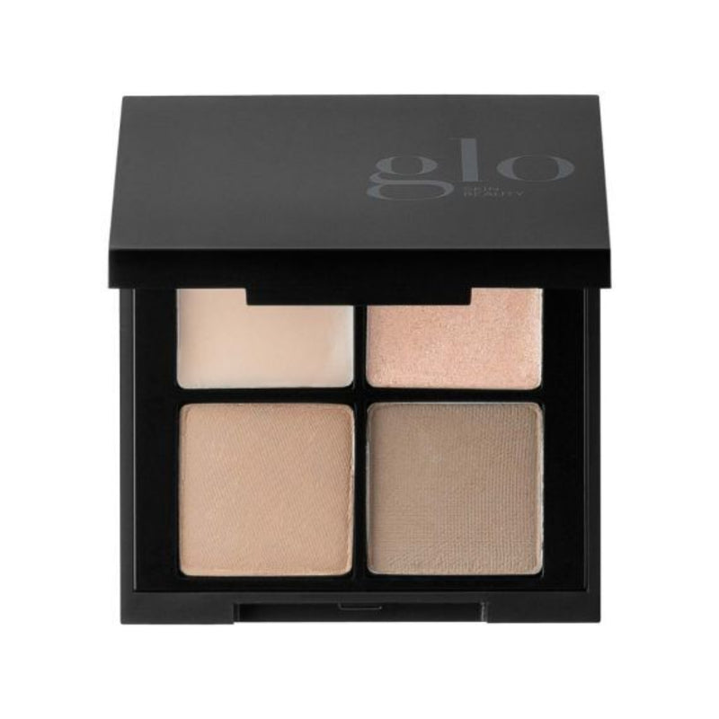 Makeup palette with four beige shades in a black 'glo' box on a white background