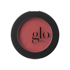 Round blush compact with pink shade and 'glo Skin Beauty' branding on a white background