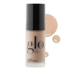 Glo Skin Beauty Luminous Liquid Foundation bottle with applicator on a white background