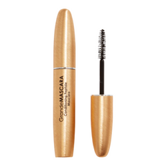Mascara with gold casing and black brush on a white background