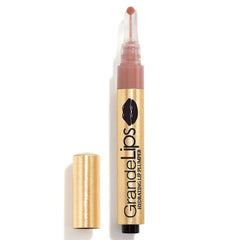 Lip plumper with gold cap and clear casing on a white background