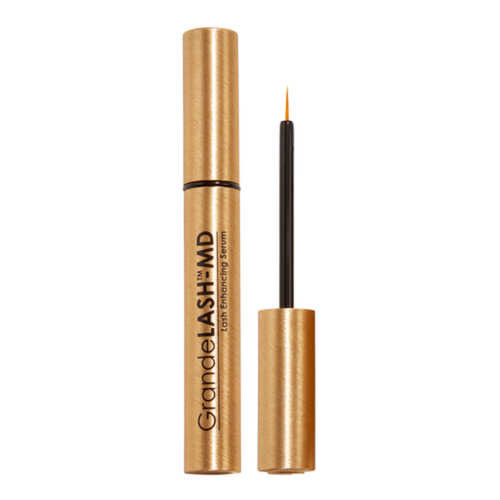 Bronze-colored eyelash serum with applicator on a white background